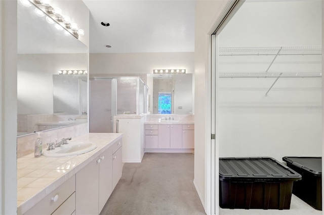 3388 Highlands Bridge Rd, Sarasota, FL 34235 - bathroom with a shower stall, two vanities, and a walk in closet