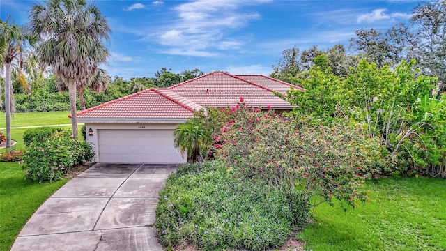 3388 Highlands Bridge Rd, Sarasota, FL 34235 - view of property exterior featuring a tile roof, a garage, concrete driveway, a lawn, and stucco siding