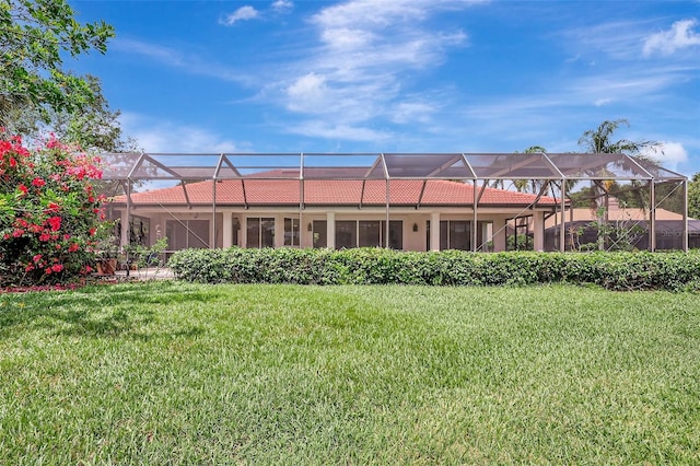 3388 Highlands Bridge Rd, Sarasota, FL 34235 - rear view of property featuring a yard, a tiled roof, and glass enclosure