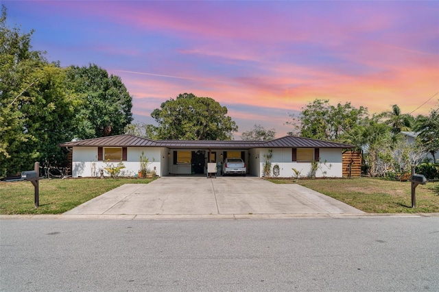 3921 Marlborough Pl, Sarasota, FL 34241 - view of front of property with a standing seam roof, a front lawn, metal roof, and a carport