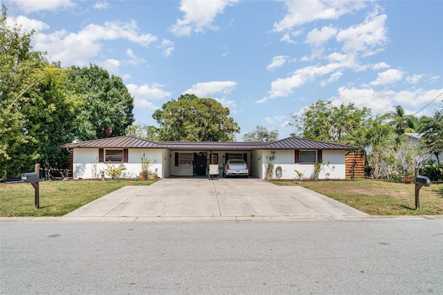 3921 Marlborough Pl, Sarasota, FL 34241 - ranch-style home with a standing seam roof, metal roof, a front lawn, an attached carport, and concrete driveway