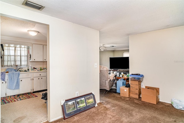 3921 Marlborough Pl, Sarasota, FL 34241 - living area with light colored carpet, a textured ceiling, and a ceiling fan
