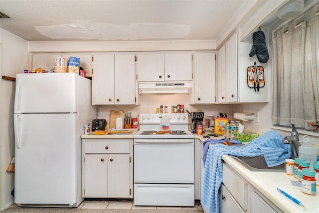 3921 Marlborough Pl, Sarasota, FL 34241 - kitchen with white appliances, under cabinet range hood, light countertops, and a textured ceiling