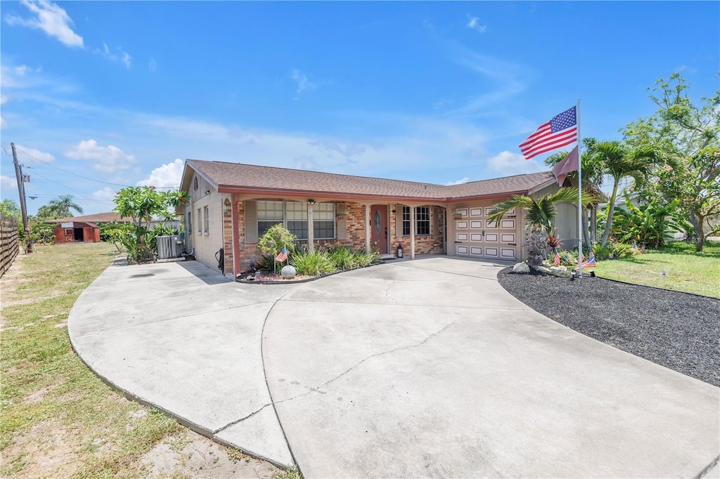 3311 Florida Blvd, Bradenton, FL 34207 - single story home with concrete driveway, an attached garage, central air condition unit, a front lawn, and brick siding