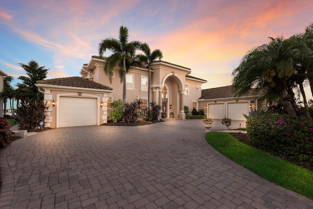 801 3rd St E, Palmetto, FL 34221 - mediterranean / spanish house with a garage, decorative driveway, and stucco siding