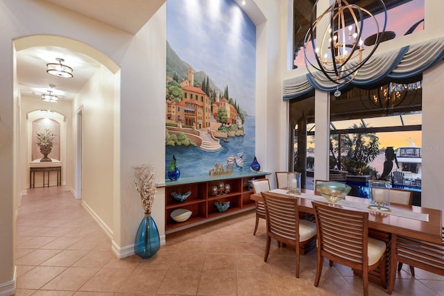 801 3rd St E, Palmetto, FL 34221 - dining area with arched walkways, a chandelier, tile patterned floors, and baseboards