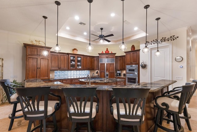 801 3rd St E, Palmetto, FL 34221 - kitchen featuring paneled built in refrigerator, a spacious island, ceiling fan, double oven, and tasteful backsplash