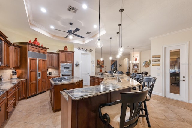 801 3rd St E, Palmetto, FL 34221 - kitchen featuring a spacious island, a sink, stainless steel appliances, crown molding, and light tile patterned flooring
