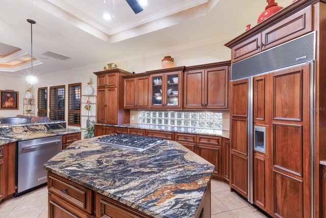 801 3rd St E, Palmetto, FL 34221 - kitchen with appliances with stainless steel finishes, a tray ceiling, light tile patterned floors, and crown molding