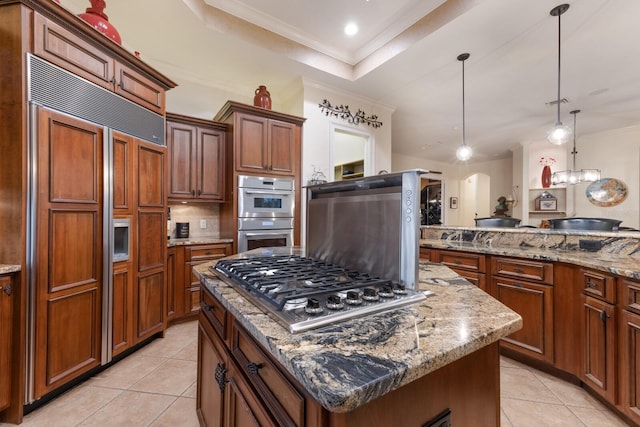 801 3rd St E, Palmetto, FL 34221 - kitchen with stainless steel appliances, ornamental molding, a center island, light tile patterned flooring, and a raised ceiling