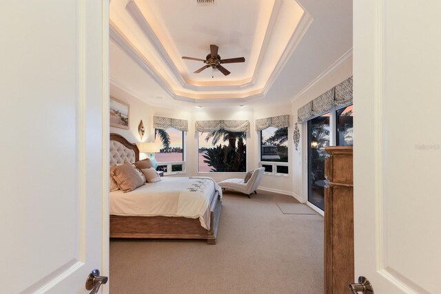 801 3rd St E, Palmetto, FL 34221 - carpeted bedroom with a raised ceiling, crown molding, and a ceiling fan