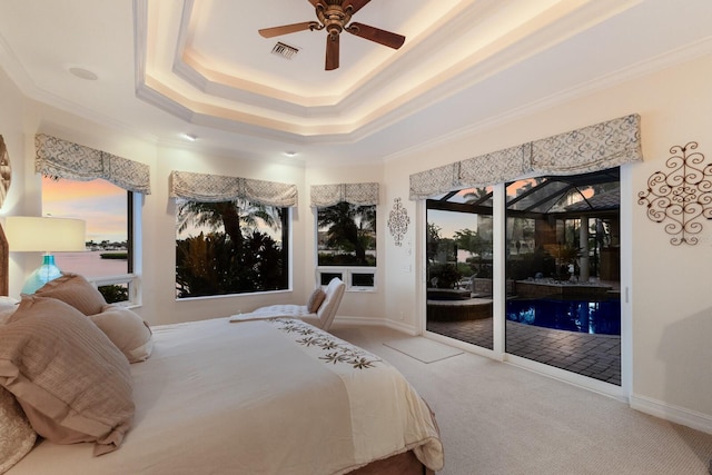 801 3rd St E, Palmetto, FL 34221 - carpeted bedroom with access to exterior, a tray ceiling, ceiling fan, and ornamental molding