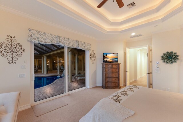801 3rd St E, Palmetto, FL 34221 - carpeted bedroom with crown molding, a raised ceiling, a ceiling fan, and baseboards