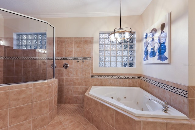 801 3rd St E, Palmetto, FL 34221 - bathroom featuring a tub with jets, a walk in shower, ornamental molding, and a chandelier