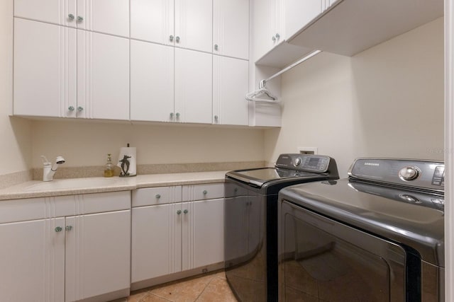 801 3rd St E, Palmetto, FL 34221 - laundry room with washer and clothes dryer, cabinet space, and light tile patterned floors