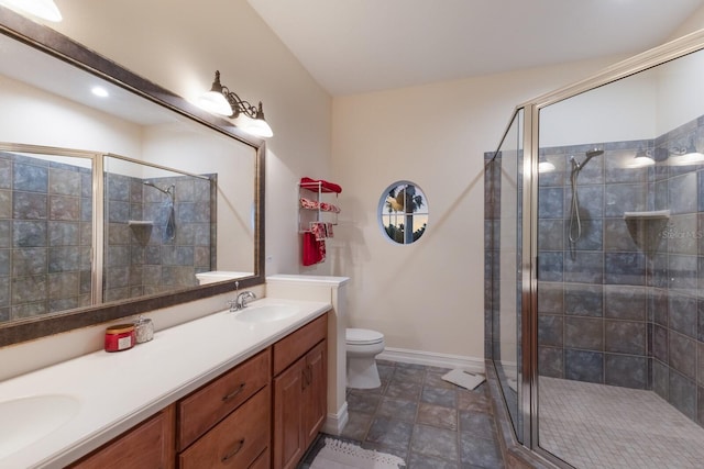 801 3rd St E, Palmetto, FL 34221 - full bathroom with double vanity, a shower stall, toilet, and baseboards