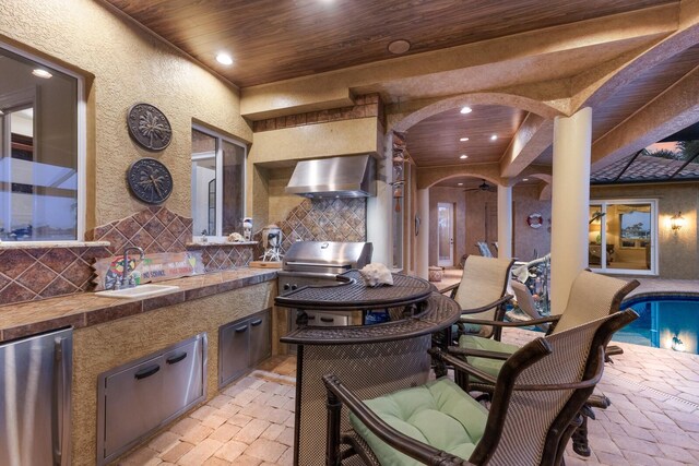 801 3rd St E, Palmetto, FL 34221 - view of patio / terrace featuring exterior kitchen, a sink, and an outdoor pool