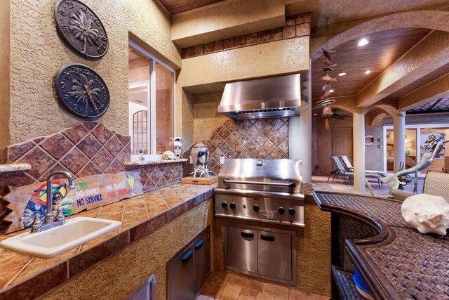 801 3rd St E, Palmetto, FL 34221 - kitchen with a sink, wall chimney range hood, tasteful backsplash, recessed lighting, and tile countertops
