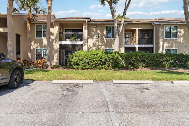 4061 Crockers Lake Blvd Unit 27, Sarasota, FL 34238 - view of building exterior with uncovered parking
