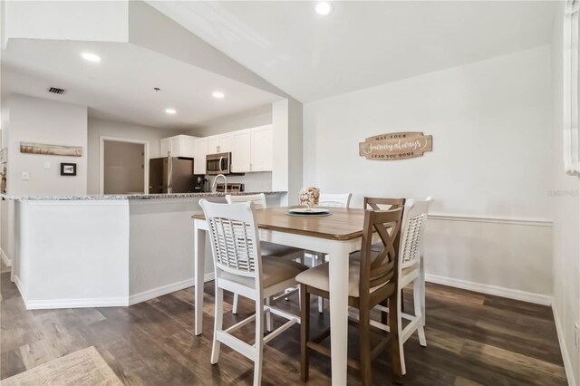 4061 Crockers Lake Blvd Unit 27, Sarasota, FL 34238 - dining room featuring lofted ceiling, dark wood finished floors, recessed lighting, and baseboards