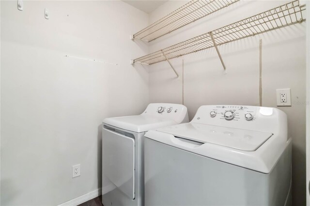 4061 Crockers Lake Blvd Unit 27, Sarasota, FL 34238 - laundry area with washer and clothes dryer and baseboards