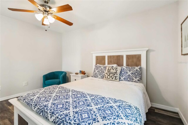 4061 Crockers Lake Blvd Unit 27, Sarasota, FL 34238 - bedroom featuring dark wood finished floors, baseboards, and ceiling fan