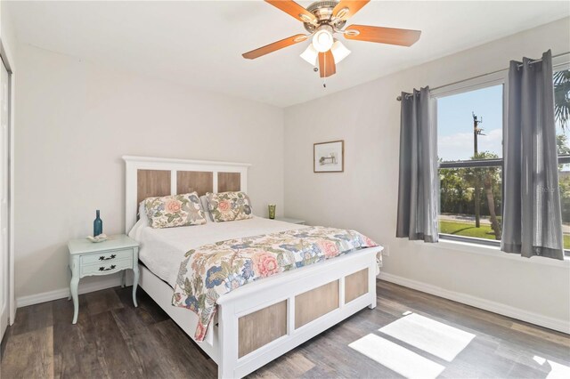4061 Crockers Lake Blvd Unit 27, Sarasota, FL 34238 - bedroom with multiple windows, baseboards, and wood finished floors