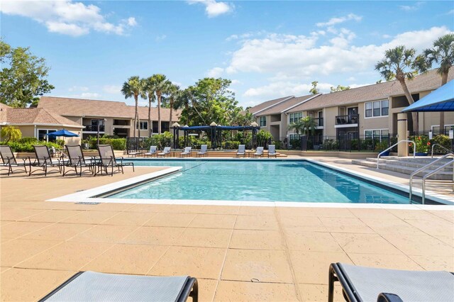 4061 Crockers Lake Blvd Unit 27, Sarasota, FL 34238 - community pool featuring a patio area and a residential view