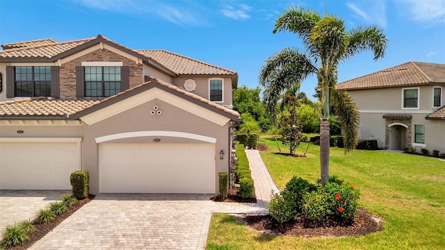 5843 Wake Forest Run Unit 104, Bradenton, FL 34211 - view of front of home featuring a tile roof, decorative driveway, a front yard, and stucco siding