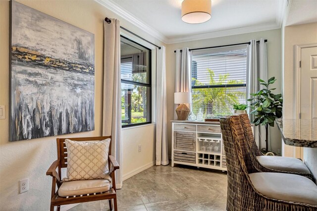 5843 Wake Forest Run Unit 104, Bradenton, FL 34211 - sitting room featuring healthy amount of natural light, ornamental molding, and baseboards