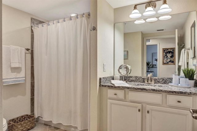 5843 Wake Forest Run Unit 104, Bradenton, FL 34211 - full bathroom with vanity, toilet, and tile patterned flooring