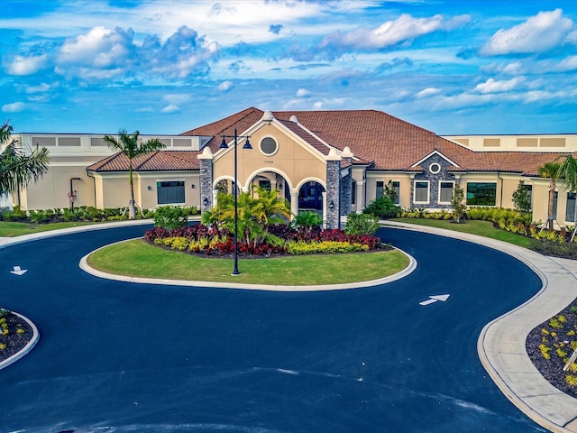 5843 Wake Forest Run Unit 104, Bradenton, FL 34211 - view of building exterior with curved driveway