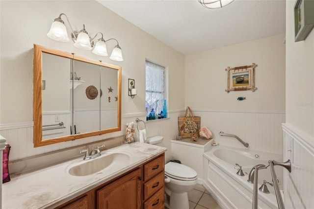 1190 Jamaica Rd, Venice, FL 34293 - bathroom featuring wainscoting, a garden tub, vanity, toilet, and tile patterned floors