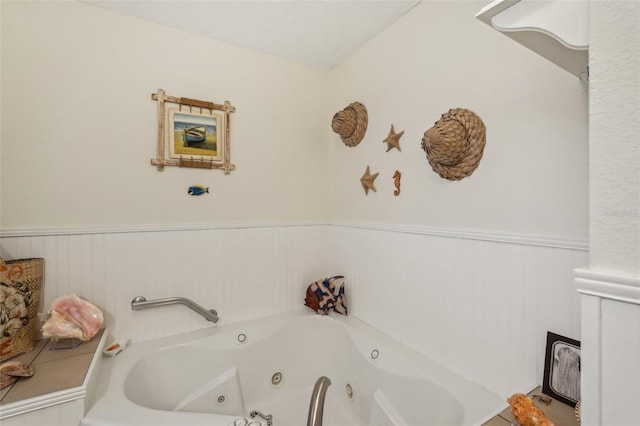 1190 Jamaica Rd, Venice, FL 34293 - bathroom with a whirlpool tub and a wainscoted wall