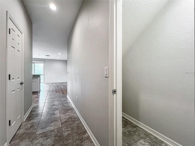 1053 Grantham Dr, Sarasota, FL 34234 - corridor with baseboards and dark stone finish floors