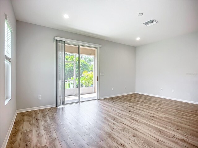 1053 Grantham Dr, Sarasota, FL 34234 - unfurnished room featuring wood finished floors, recessed lighting, and baseboards
