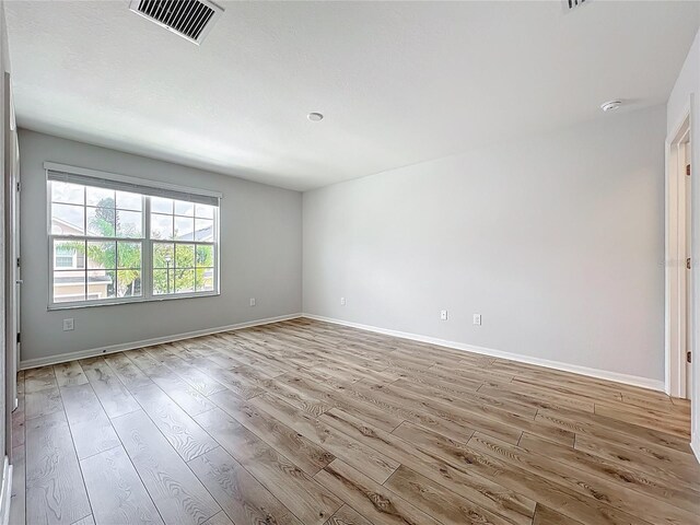 1053 Grantham Dr, Sarasota, FL 34234 - empty room with light wood-type flooring, baseboards, and a smoke detector