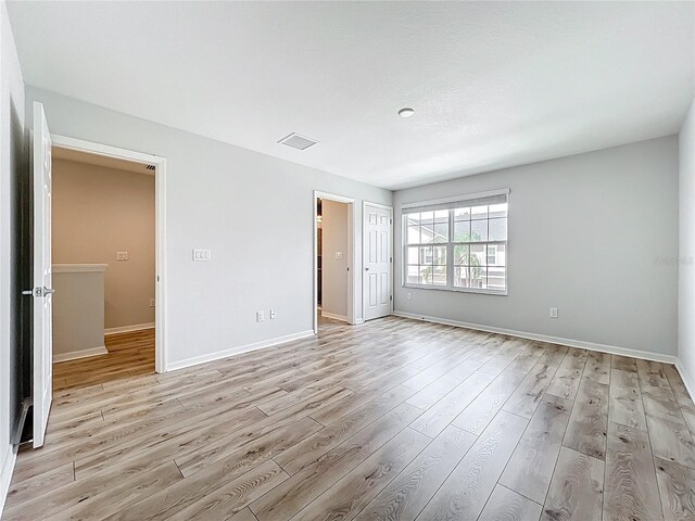 1053 Grantham Dr, Sarasota, FL 34234 - unfurnished bedroom featuring light wood-style flooring and baseboards