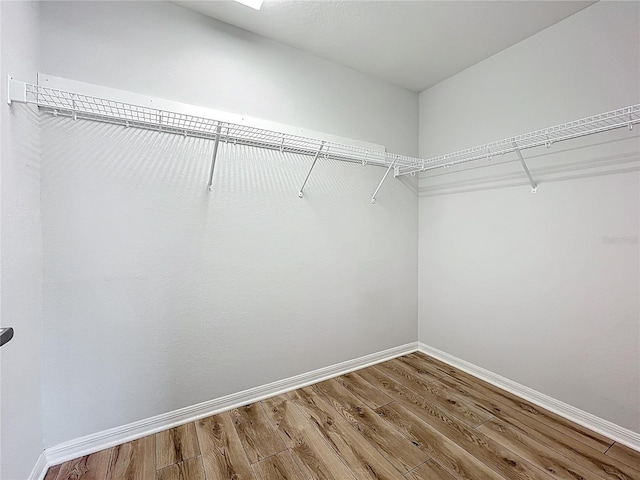 1053 Grantham Dr, Sarasota, FL 34234 - walk in closet featuring wood finished floors