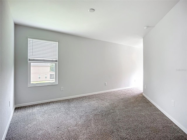 1053 Grantham Dr, Sarasota, FL 34234 - empty room with carpet, baseboards, and a smoke detector