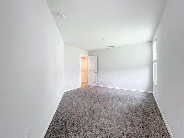 1053 Grantham Dr, Sarasota, FL 34234 - carpeted spare room with baseboards and a smoke detector