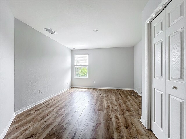 1053 Grantham Dr, Sarasota, FL 34234 - unfurnished room featuring wood finished floors and baseboards