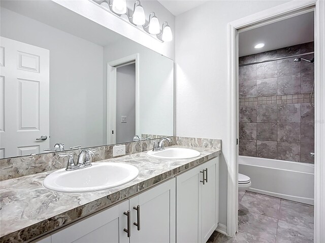 1053 Grantham Dr, Sarasota, FL 34234 - bathroom featuring double vanity, toilet, and tub / shower combination