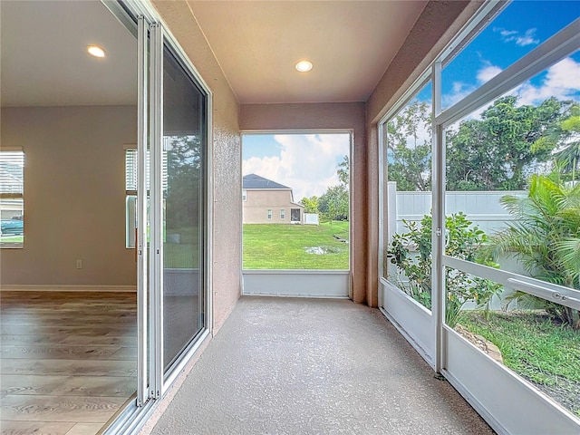 1053 Grantham Dr, Sarasota, FL 34234 - unfurnished sunroom featuring healthy amount of natural light, recessed lighting, and baseboards