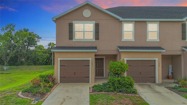 1053 Grantham Dr, Sarasota, FL 34234 - traditional-style house with a garage, concrete driveway, stucco siding, and roof with shingles