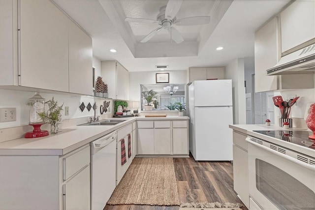6501 Mourning Dove Dr Unit 215, Bradenton, FL 34210 - kitchen with white appliances, a sink, wood finished floors, light countertops, and a raised ceiling