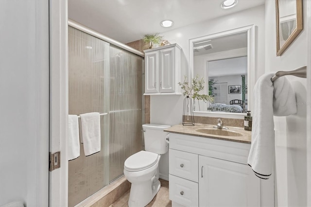 6501 Mourning Dove Dr Unit 215, Bradenton, FL 34210 - ensuite bathroom featuring vanity, a stall shower, toilet, and tile patterned flooring