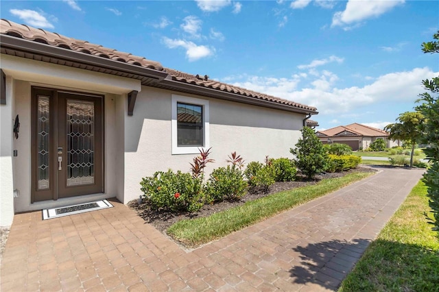 15752 Sacile Ln, Bradenton, FL 34211 - view of side of home featuring stucco siding and a tiled roof