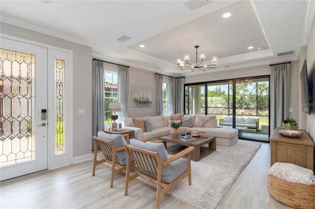 15752 Sacile Ln, Bradenton, FL 34211 - living area with a chandelier, light wood finished floors, a raised ceiling, recessed lighting, and baseboards