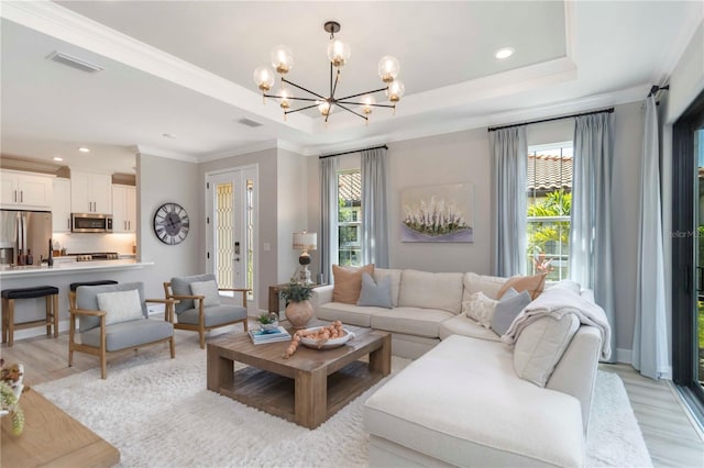 15752 Sacile Ln, Bradenton, FL 34211 - living room with a chandelier, healthy amount of natural light, light wood-style floors, crown molding, and recessed lighting